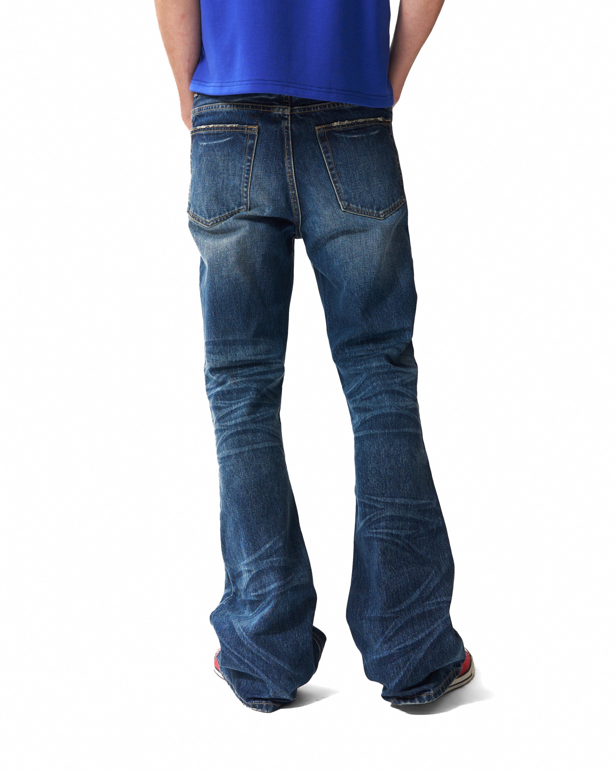 Spike-Studded Washed Flared Jeans by NUMBASIA, on a model