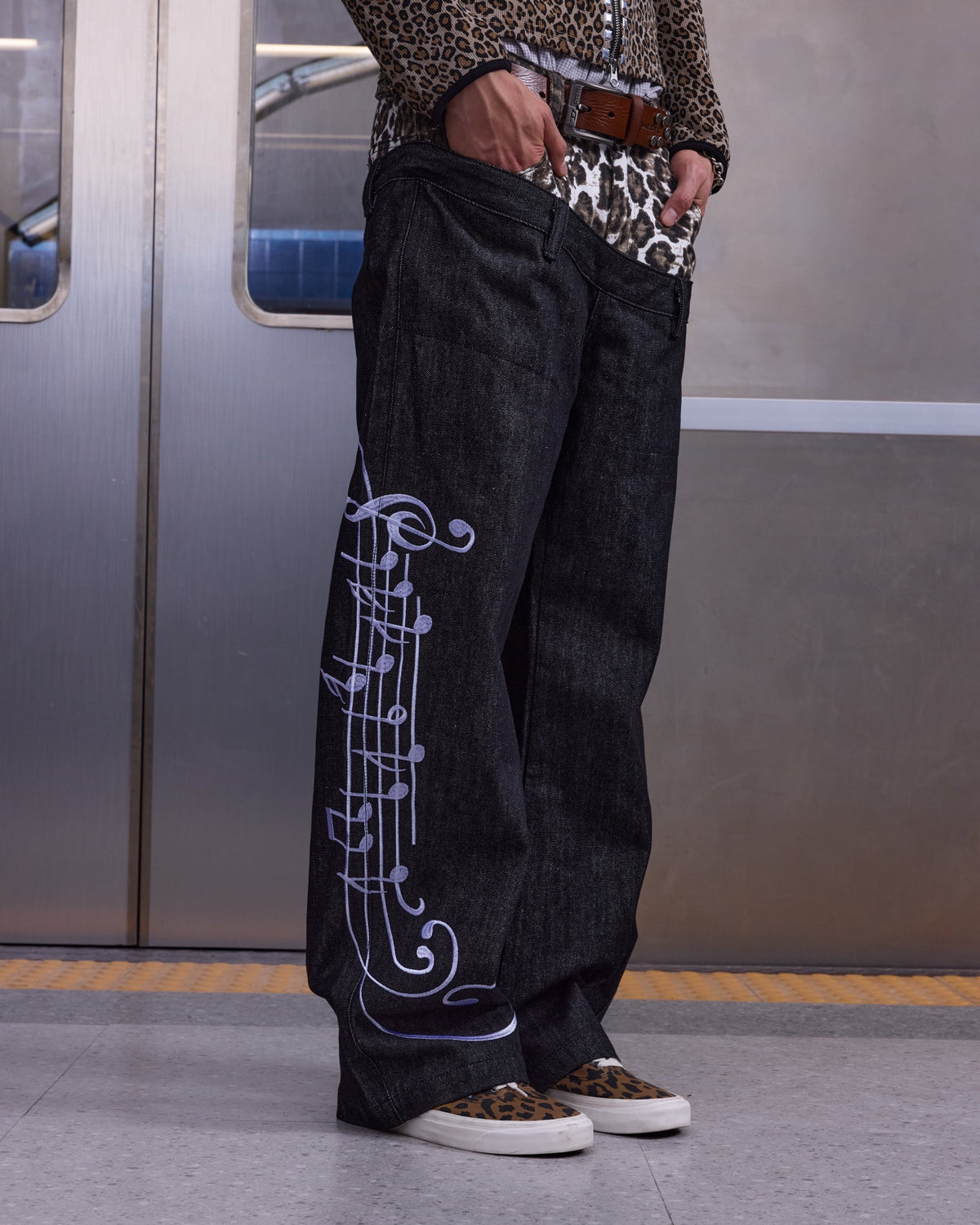 Leopard Double-Waist Music Note 13oz Baggy Jeans by NUMBASIA, on a model